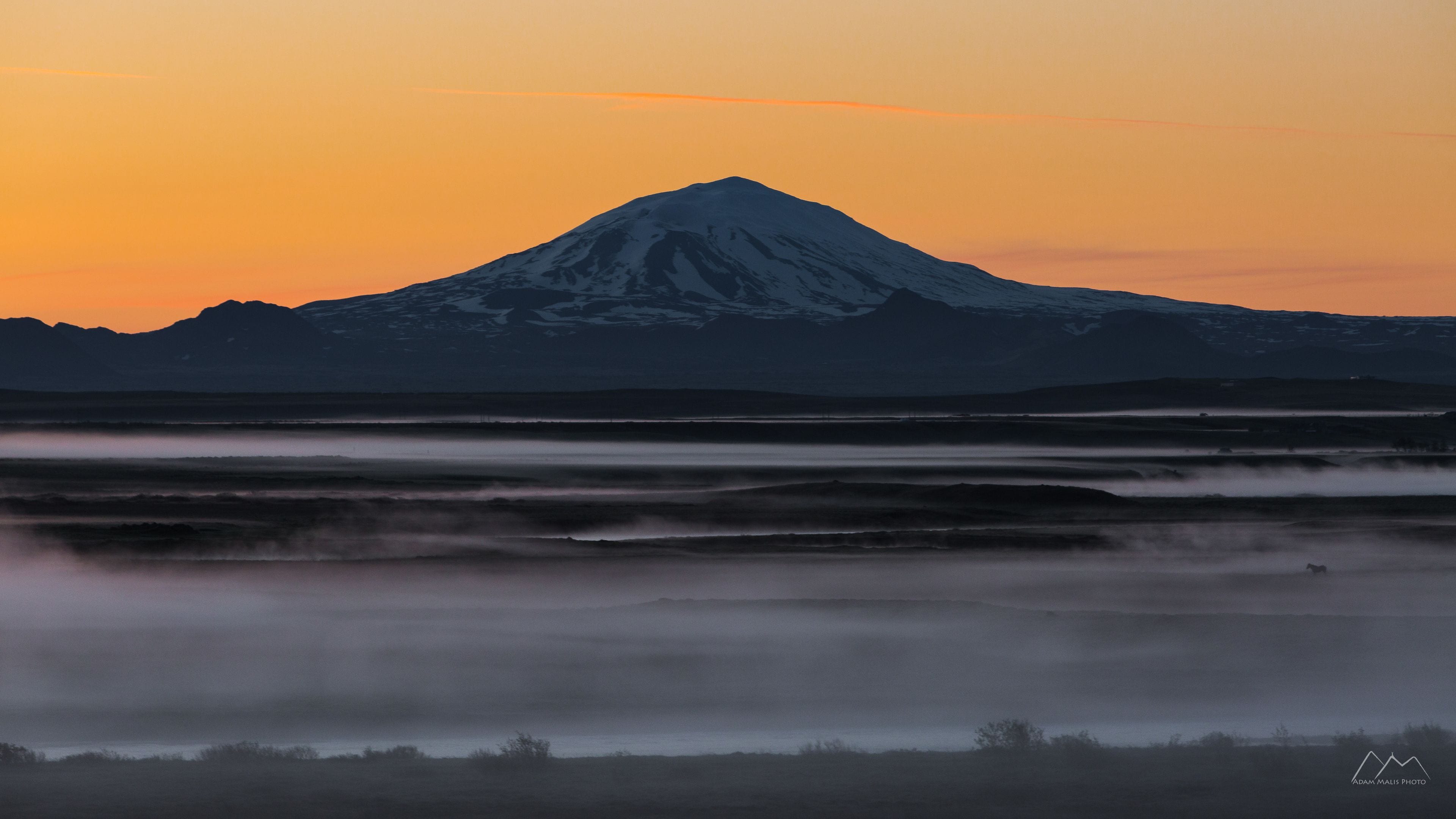 A mountain at sunrise with a clear sky.