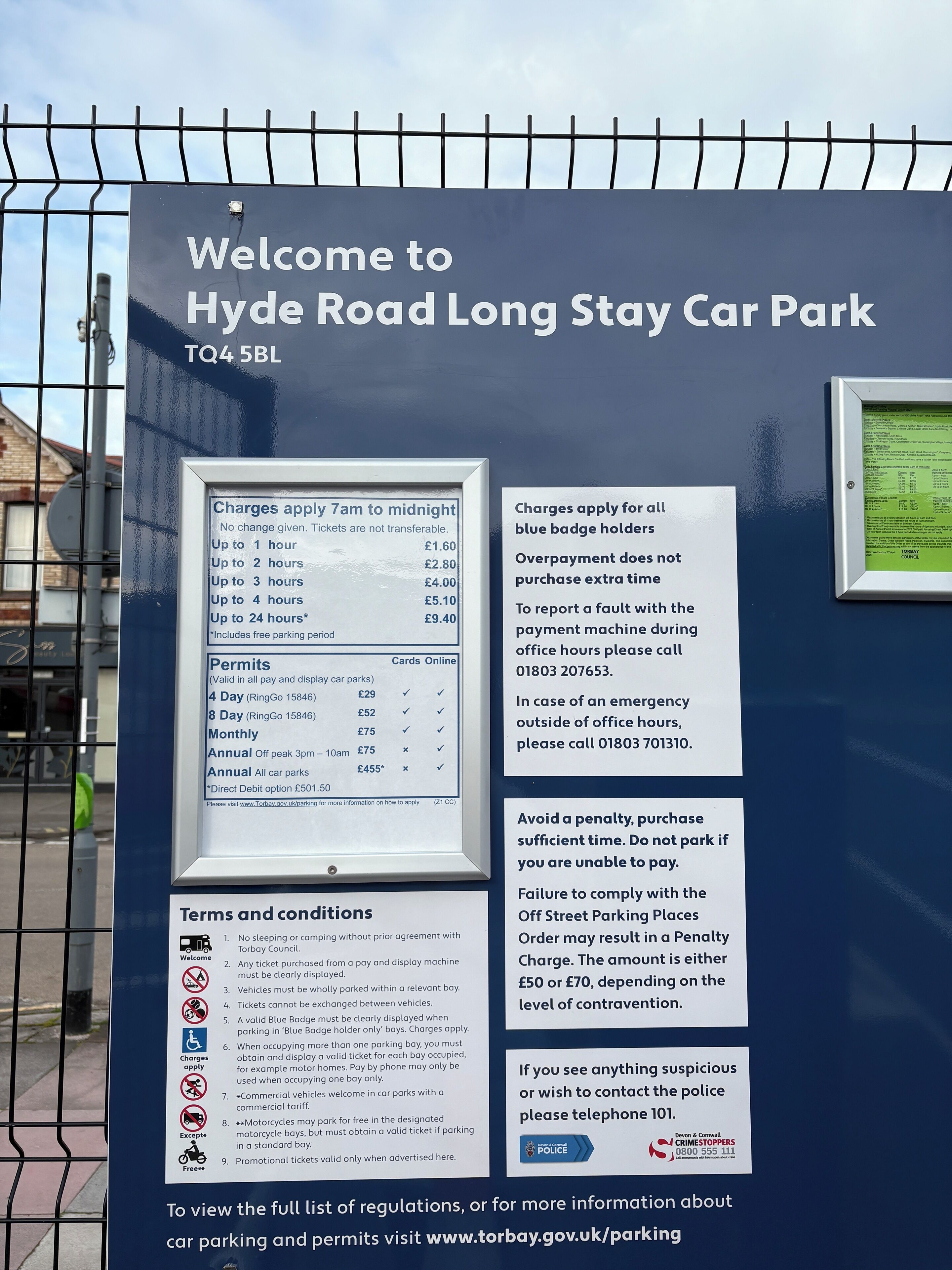 A sign for Hyde Road Long Stay Car Park detailing parking charges, permits, and terms.