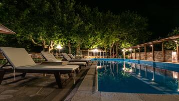 Seasonal outdoor pool, an infinity pool, pool umbrellas, pool loungers