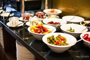 A buffet with various dishes including salads, vegetables, and meats. - Grand City Hotel Wrocław (Wroclaw)