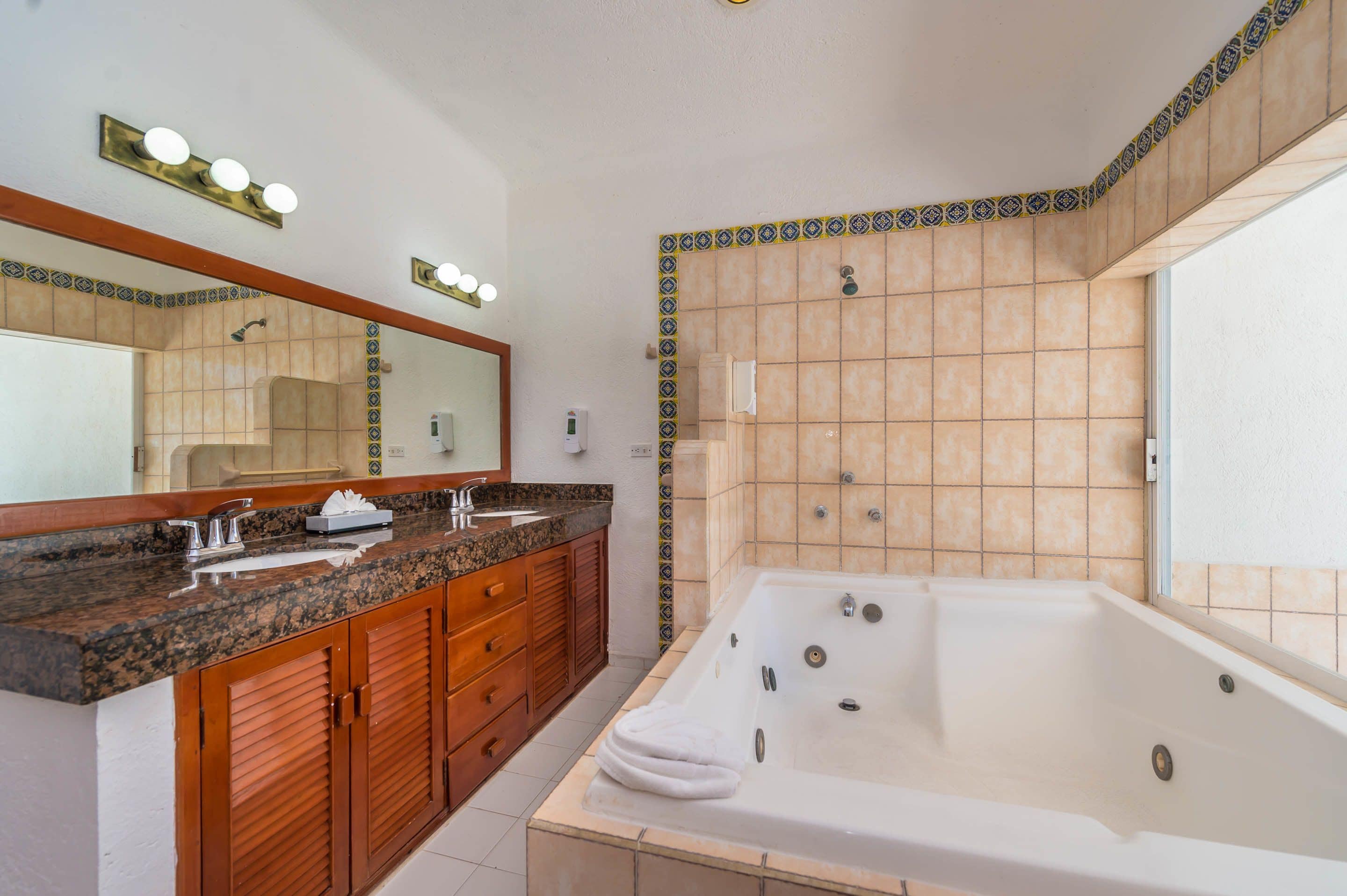 honeymoon studio suite, jetted tub, beachfront | bathroom | shower, towels, soap, shampoo
