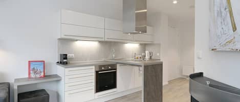 Fridge, stovetop, dishwasher, coffee/tea maker