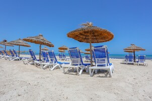 Private beach, white sand, sun loungers, beach umbrellas