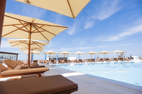 Indoor pool, outdoor pool, open 9:00 AM to 7:00 PM, pool umbrellas