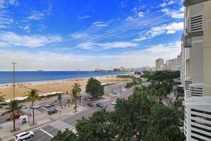 A coastal cityscape with a beach, buildings, and a clear sky. - Rio Spot Atlantica 2440 (Rio de Janeiro)