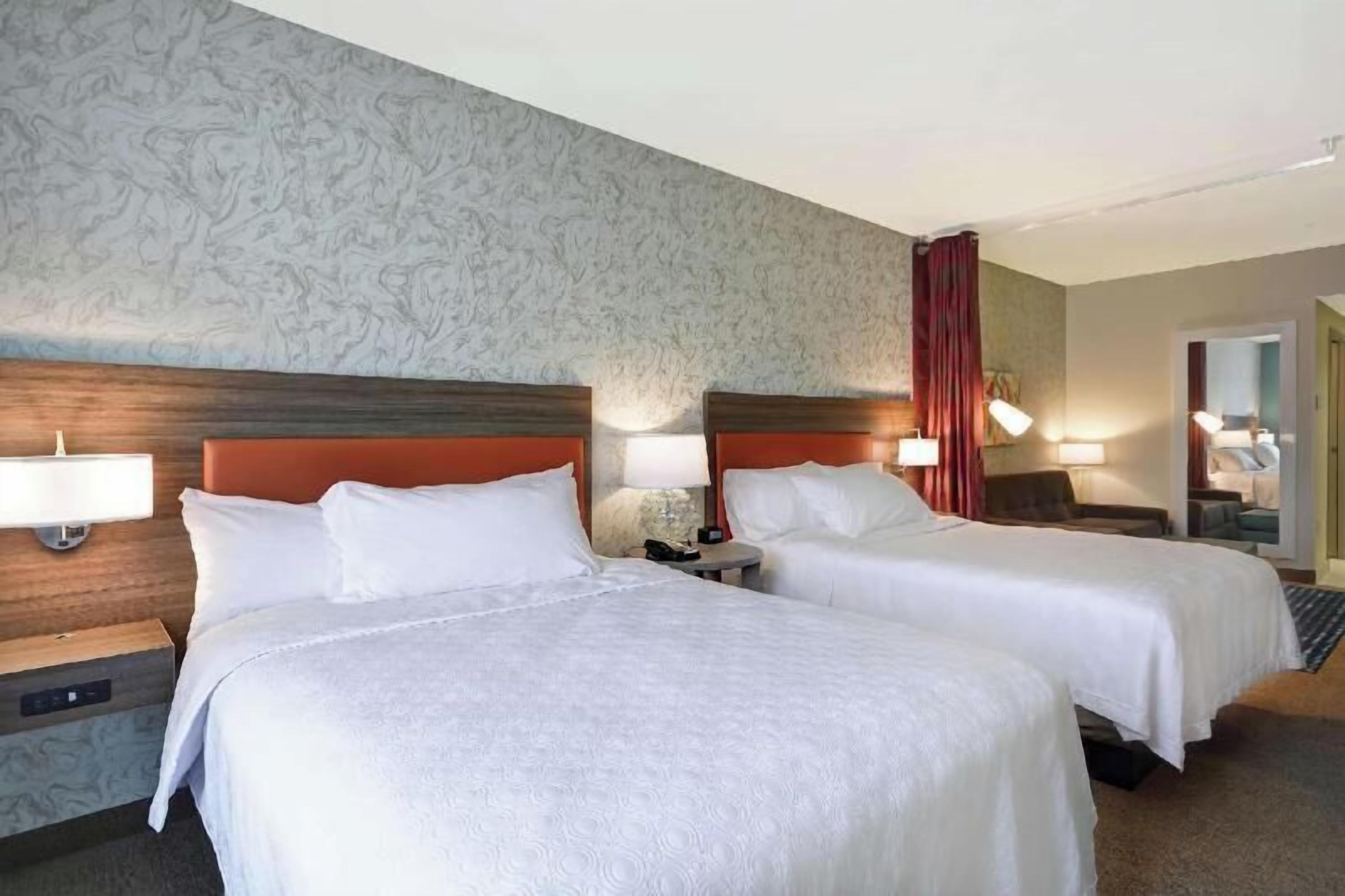 Premium bedding, desk, laptop workspace, blackout drapes