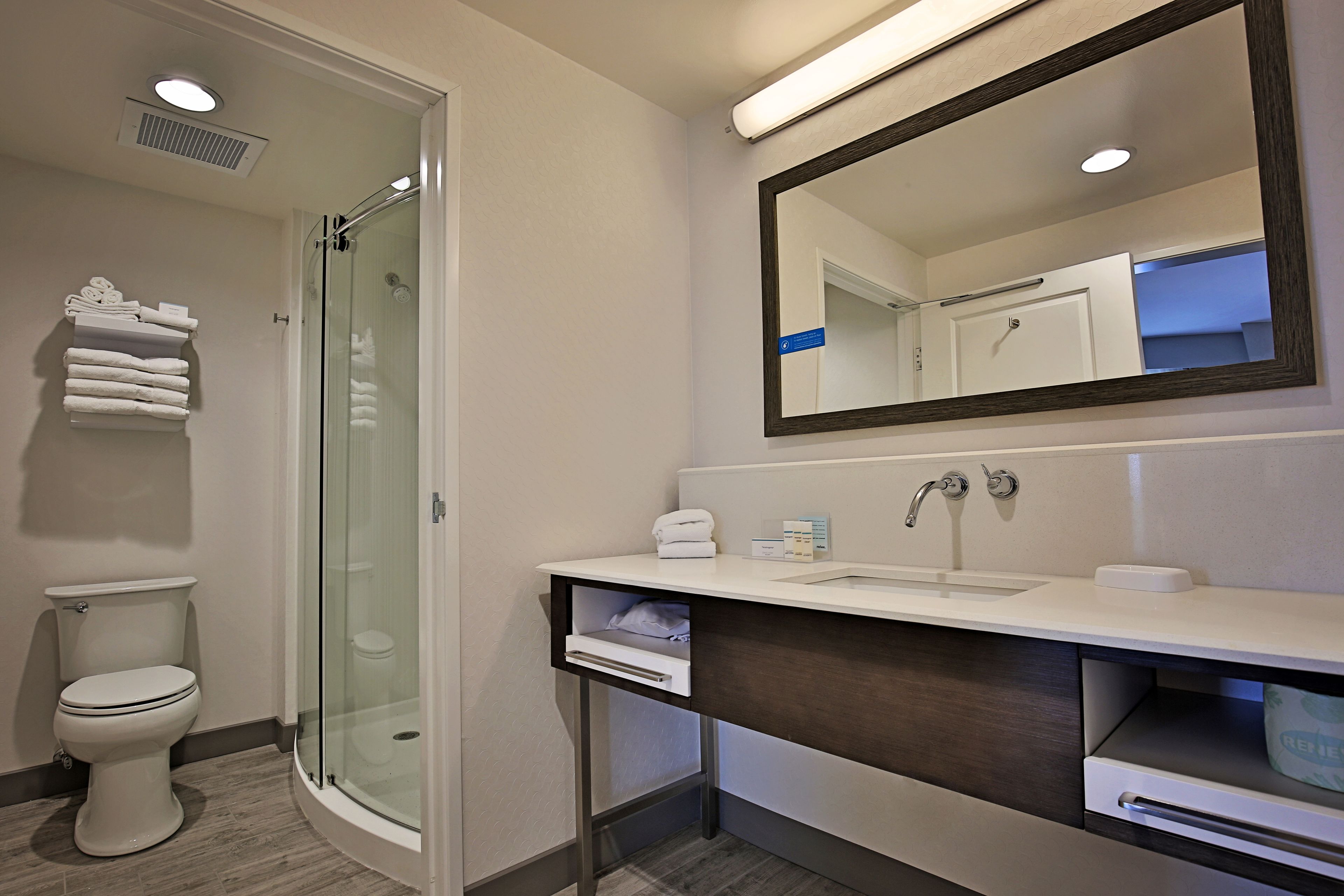 designer toiletries, hair dryer, towels