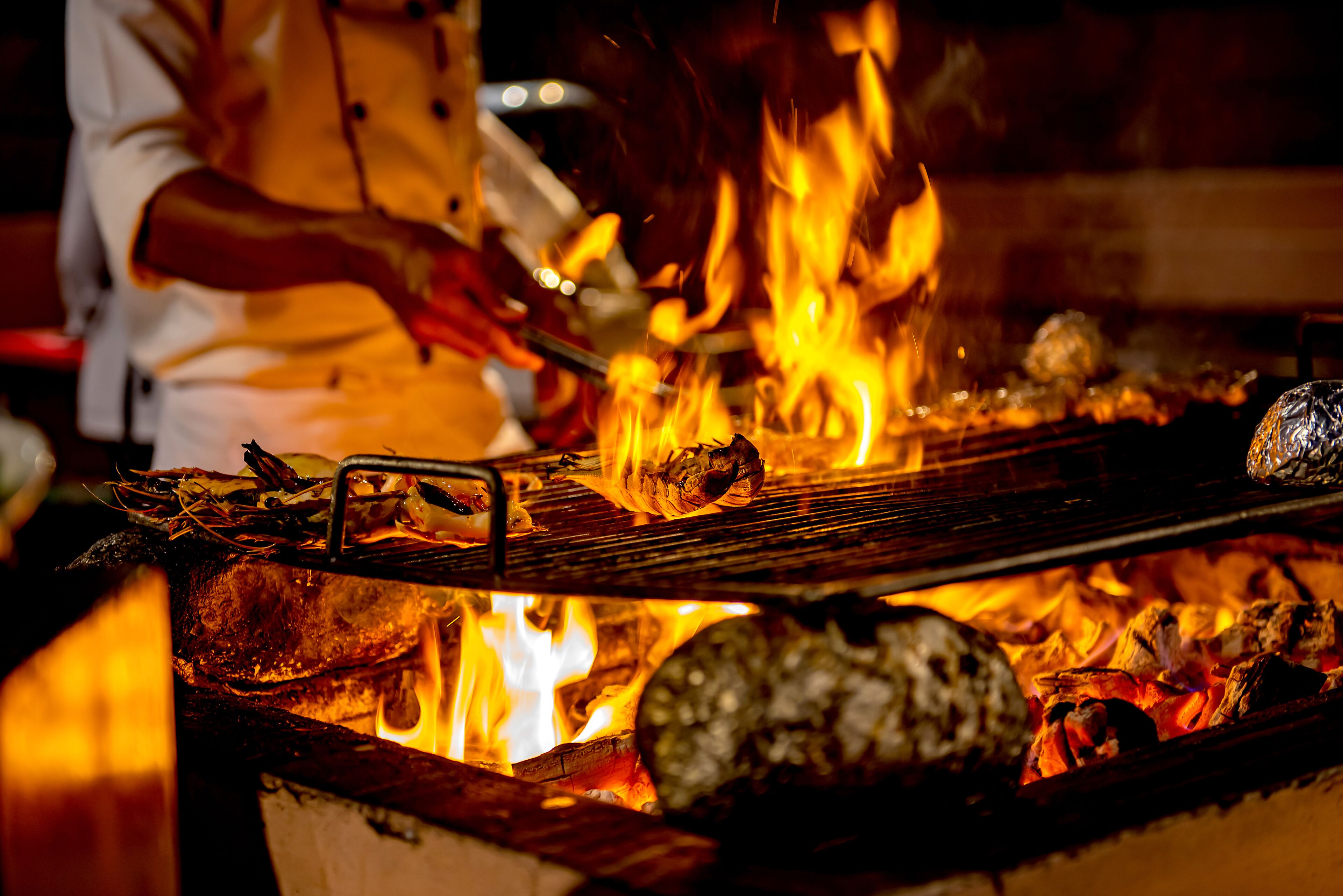 A close-up of a grill with food being cooked over an open flame.