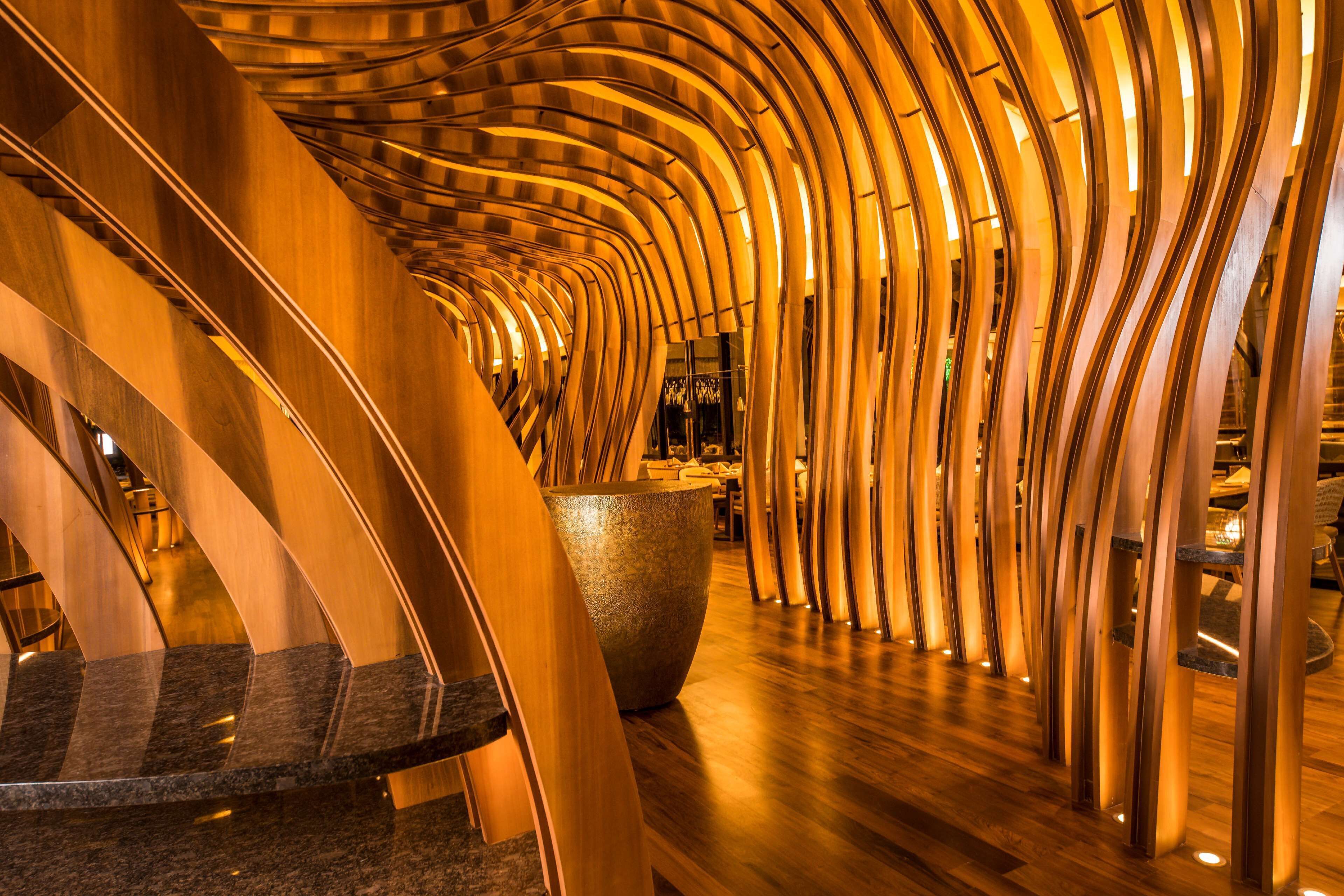 A modern interior with curved wooden structures and a large central bowl.