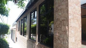 A building facade with large windows and stone walls.