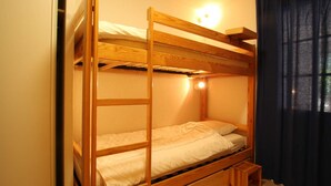 A bunk bed room with a wooden frame, a small step stool, and a light fixture above the top bunk. - Mountain Area Studio for 4 in Chantemerle, Serre-Chevalier (Saint-Chaffrey)