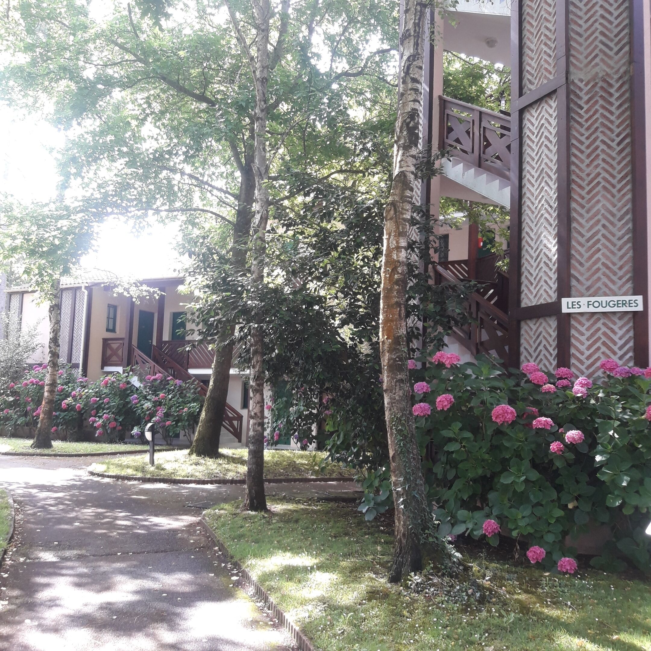 A pathway leading to a building with a sign reading "LES FOUGERES".