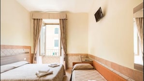 A hotel room with two beds, a TV mounted on the wall, and a balcony with curtains. - Alex Romano (Rome)