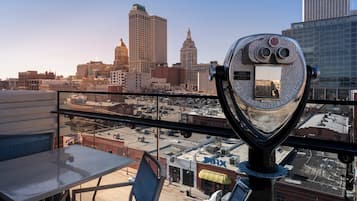 A telescope with a cityscape in the background.