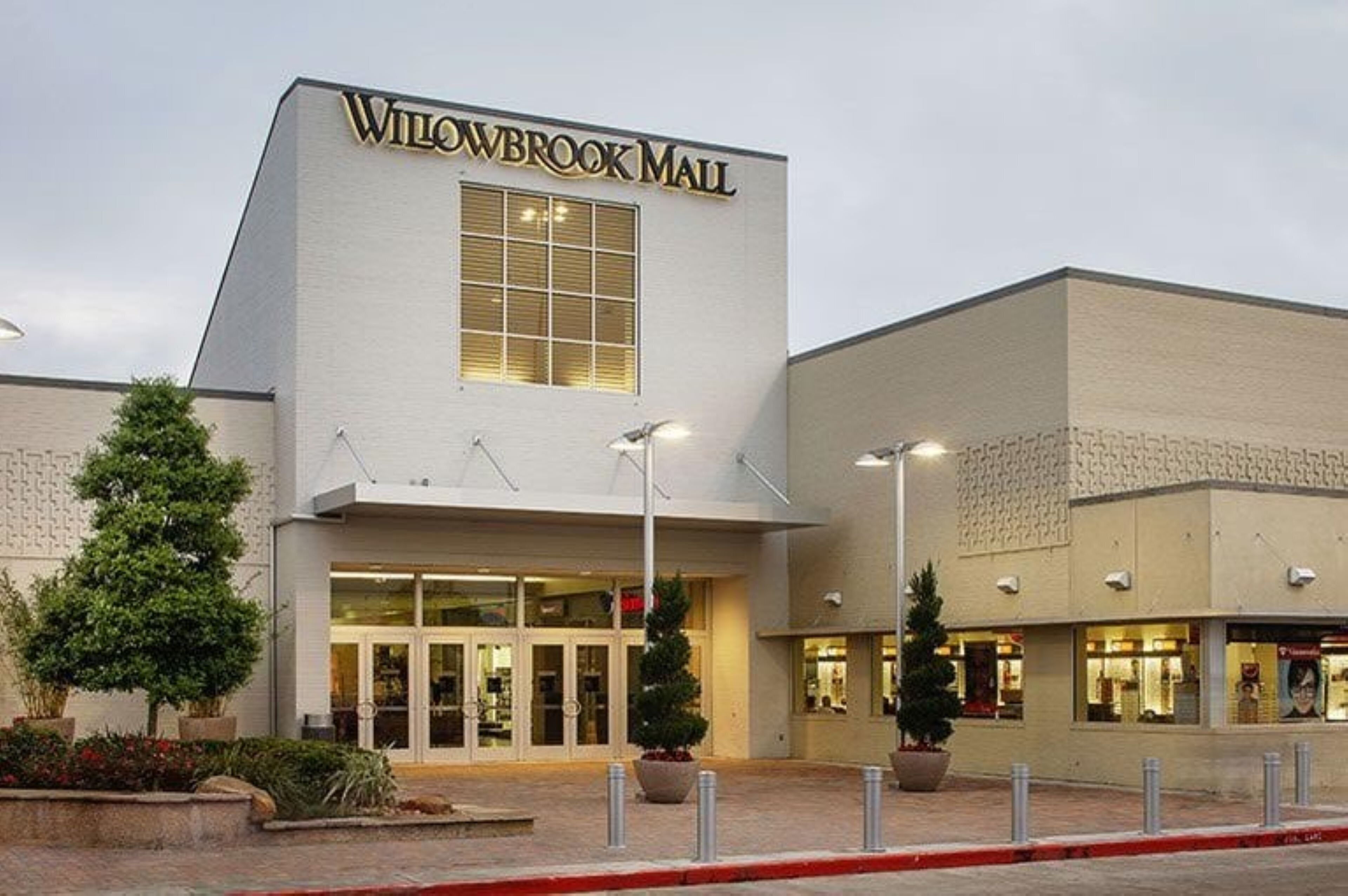 A building with a sign reading 'Willowbrook Mall' and a large entrance.