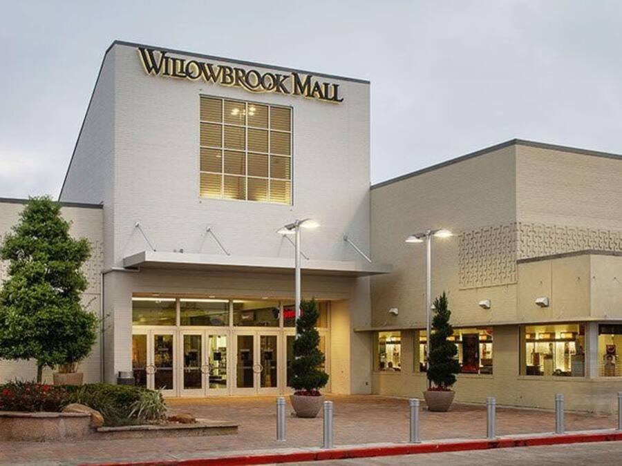 A building with a sign reading 'Willowbrook Mall' and a large entrance.