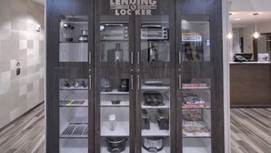 A lending locker with various items inside, including kitchenware and board games.