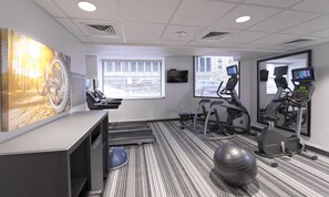 Ein Fitnessstudio mit Laufbändern, Ergometer und einem Übungsball.