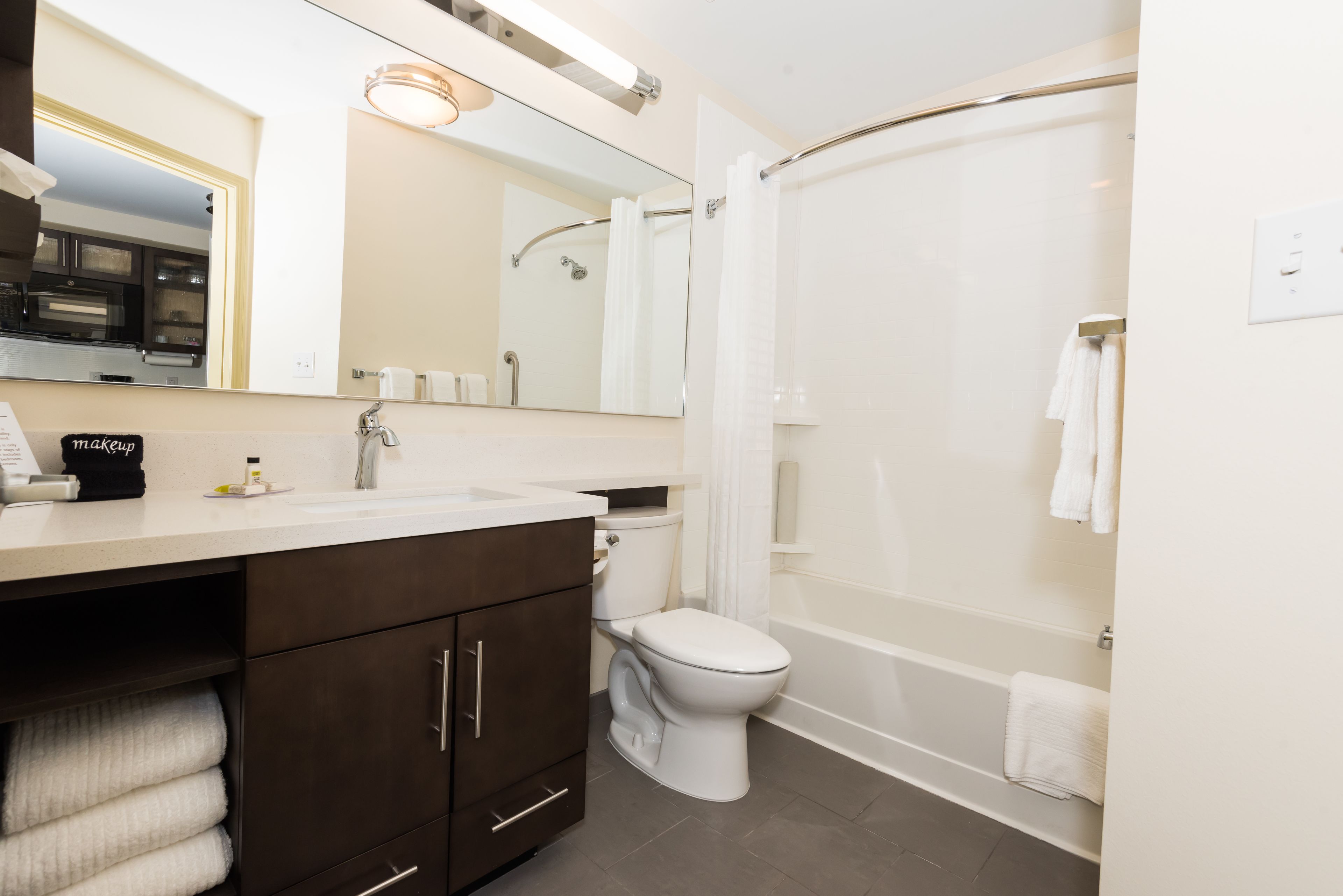 A modern bathroom with a toilet, sink, and shower.