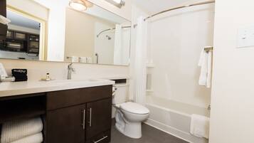A modern bathroom with a toilet, sink, and shower.