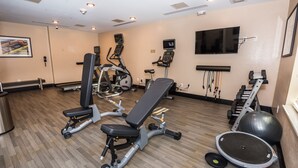 A gym with exercise equipment, a television, and a wall-mounted TV. - Candlewood Suites Ft Walton Bch - Hurlburt Area by IHG (Fort Walton Beach)