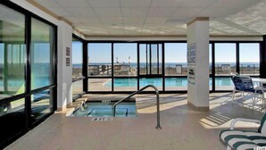 A pool area with a view of the beach, a 3ft pool, and a sign indicating no diving allowed.