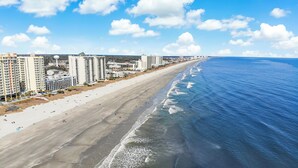 A coastal cityscape with a wide beach, high-rise buildings, and a clear sky. - Verandas 305- Oceanfront 3BR Condo-Oceanfront Pool- Walk to Main Street (NO. MYRTLE BEACH)