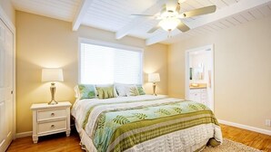 A bedroom with a bed, nightstands, a ceiling fan, a window, and a door. - Beautiful Views - Sand Section of Manhattan Beach  (Manhattan Beach)