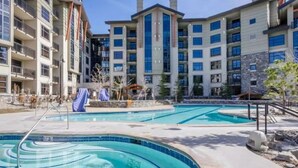 A residential building with multiple balconies and a swimming pool area.