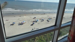A beach view from a window with a pier in the background. - Oceanfront 3BR/3B Lockout. Resort Amenities, Pools, Lazy River, Kiddie Pool (NO. MYRTLE BEACH)
