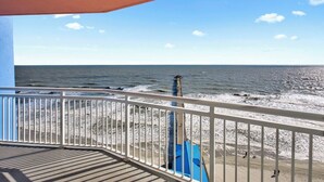 A balcony with a view of the ocean, a sandy beach, and a pier extending into the water. - Oceanfront 3BR/3B Lockout. Resort Amenities, Pools, Lazy River, Kiddie Pool (NO. MYRTLE BEACH)