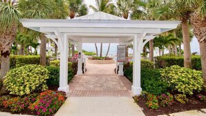 A white gazebo with a paved pathway leading to it, surrounded by palm trees and flower beds. - Islamorada Anglers Reef! “Sandbar Bungalow Villa" AMAZING! Middle row location!  (Islamorada)