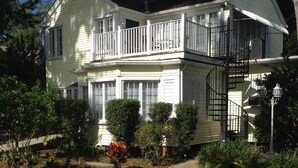 A two-story house with a balcony and a spiral staircase. - Comfy Queen large 1/1, Near Stetson, Sky Diving, St Johns River, racing, beach (Deland)