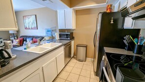 A compact kitchen with a sink, microwave, refrigerator, and stove. - Complete retreat with private hot tub. (Scottsdale)