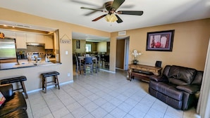 A spacious living area with a kitchen, dining table, and a leather sofa. - Complete retreat with private hot tub. (Scottsdale)