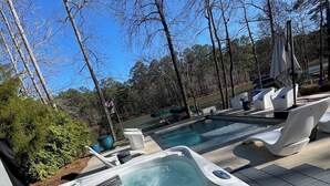 A hot tub with a view of a lake and trees. - 5 BDRM Beautiful Peaceful Lake Front Home 3 Kings, 1 Queen, 4 Twins, Pool, Spa (Greensboro)