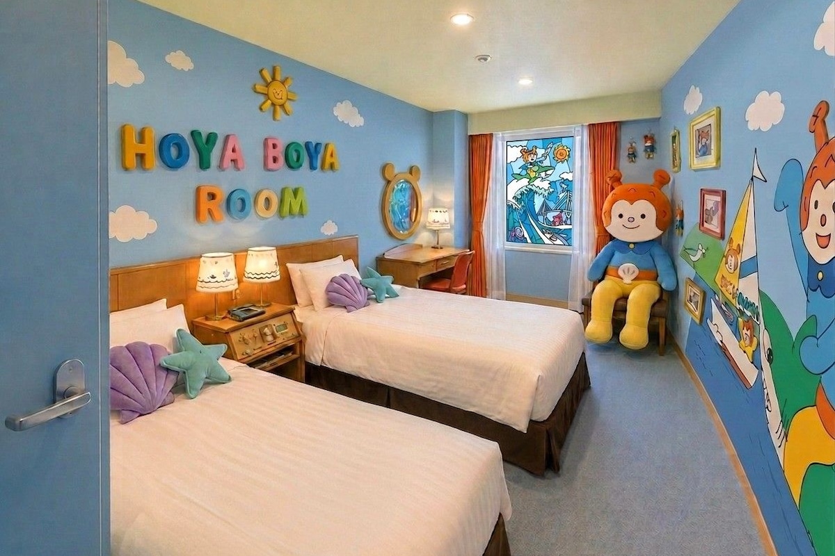 A children's room with two beds, a wall clock, and a window with curtains.