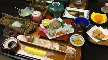 A variety of dishes and utensils on a table, suggesting a meal setting.