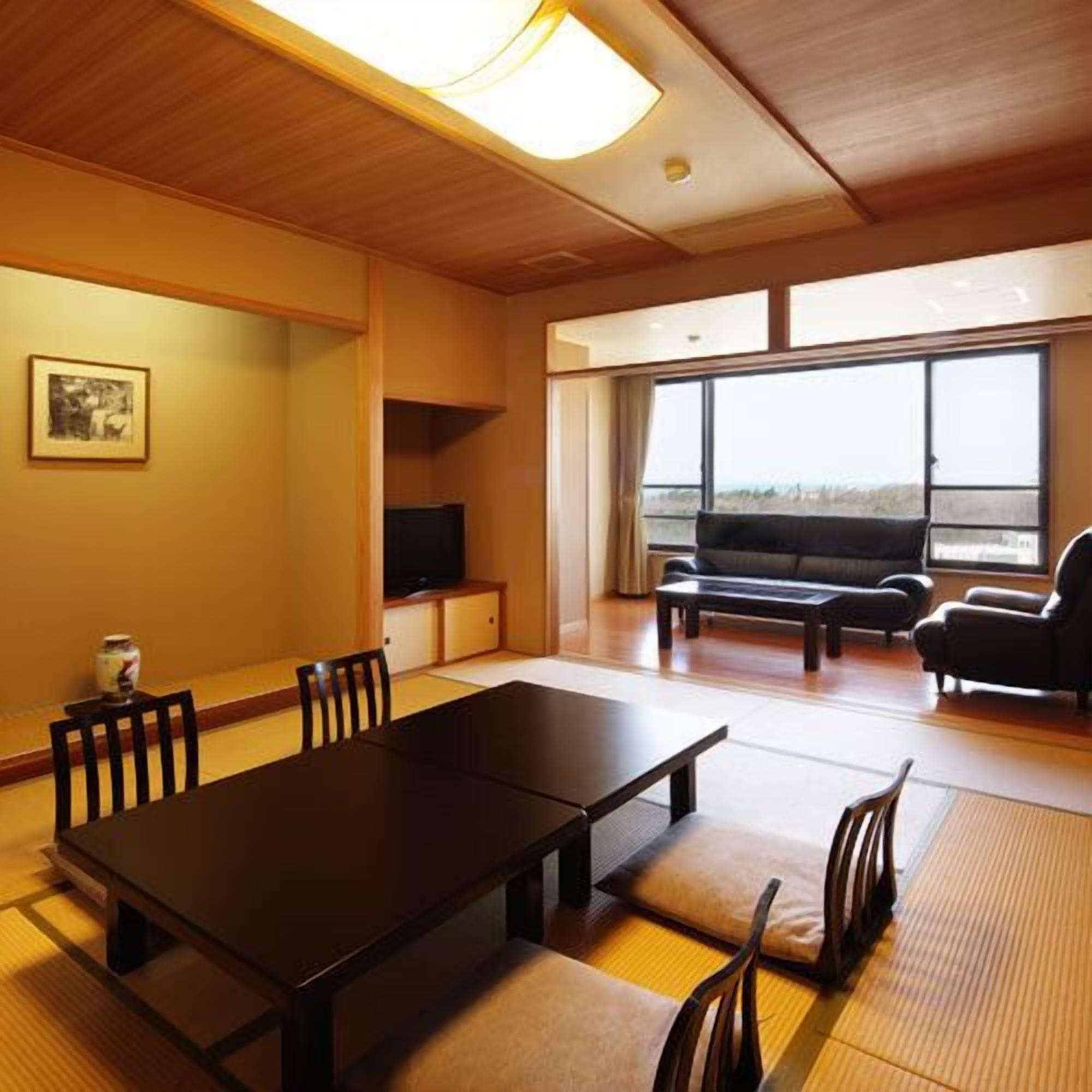 A room with a dining table, chairs, a sofa, and a television.