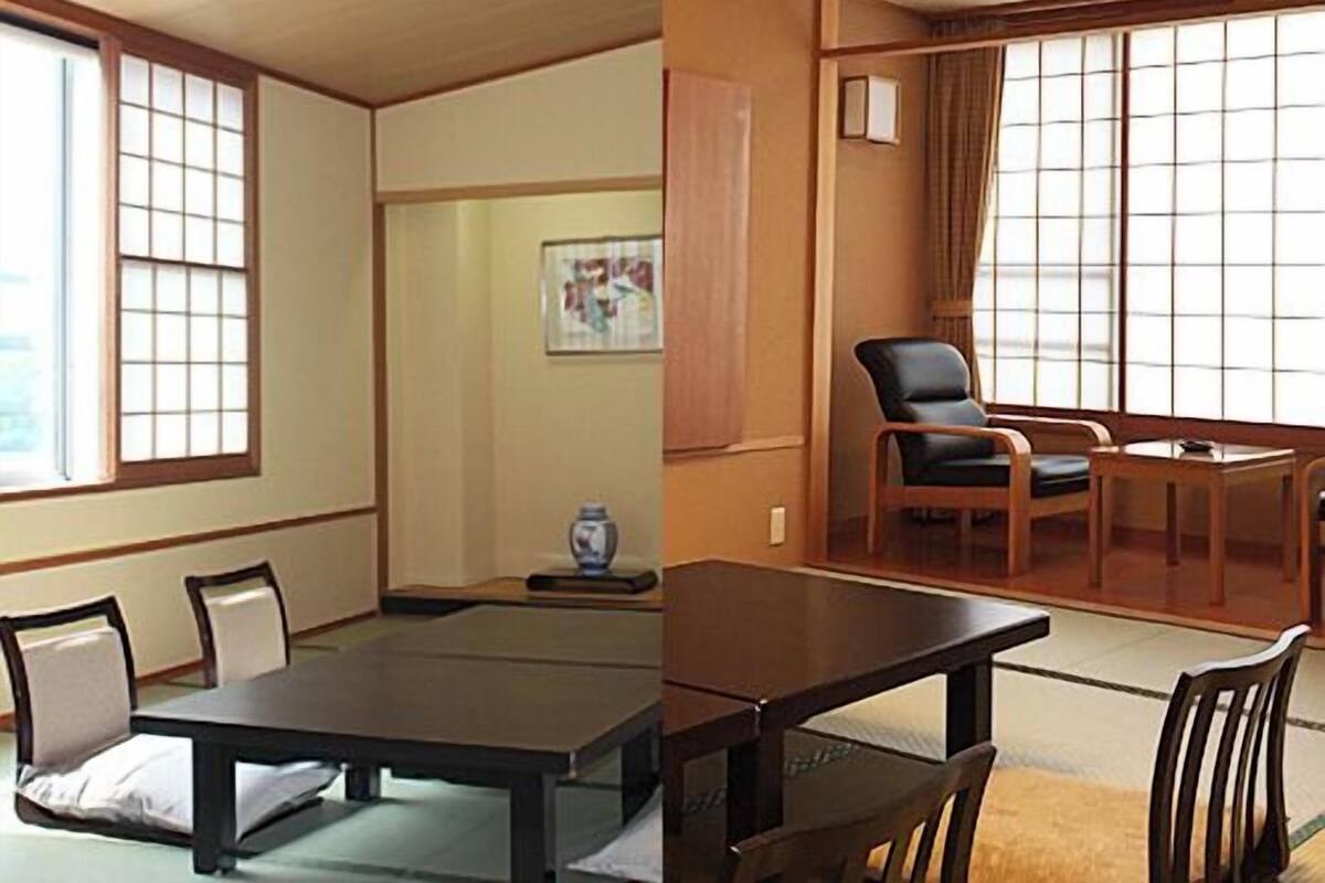 A traditional Japanese room with tatami flooring, a low table, and a sliding door.