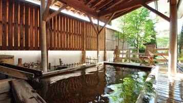 A wooden deck with a pool, wooden beams, and a chair.