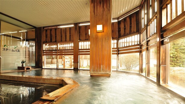 A traditional Japanese onsen with wooden interiors and large windows.