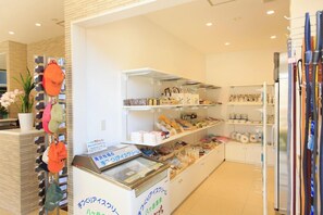 A clean, well-organized food display area with various packaged goods and a refrigerated section. - Yatsugatake Wanwan Paradise (Hokuto)