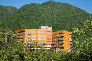 A multi-story building with a sign indicating it is a hotel.
