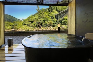A hot tub with a view of a forested hillside and a bridge. - Kurobe UnazukiOnsen Togen (Kurobe)