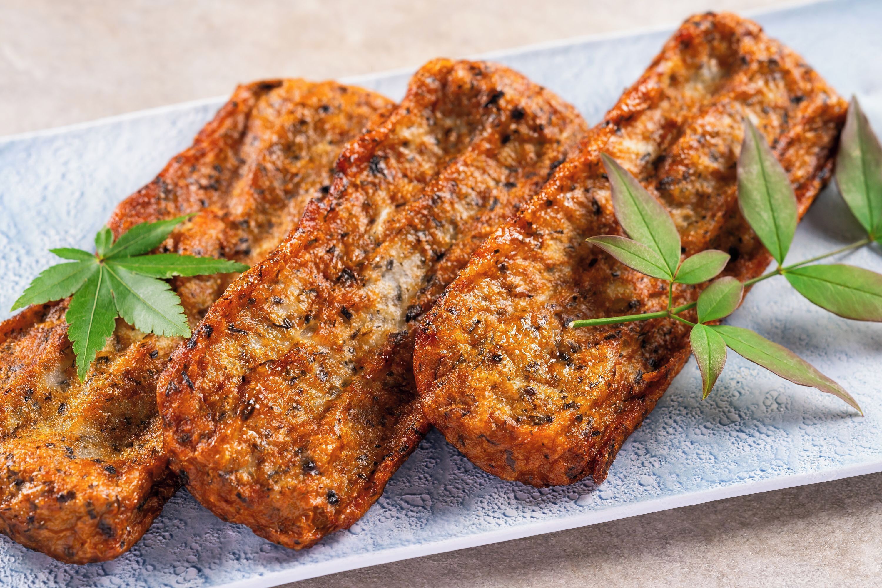 Grilled meat with herbs on a plate.