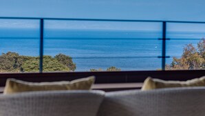 A view of a mountain from a window with a railing, a body of water, and greenery. - Futaritowani En (Izu)