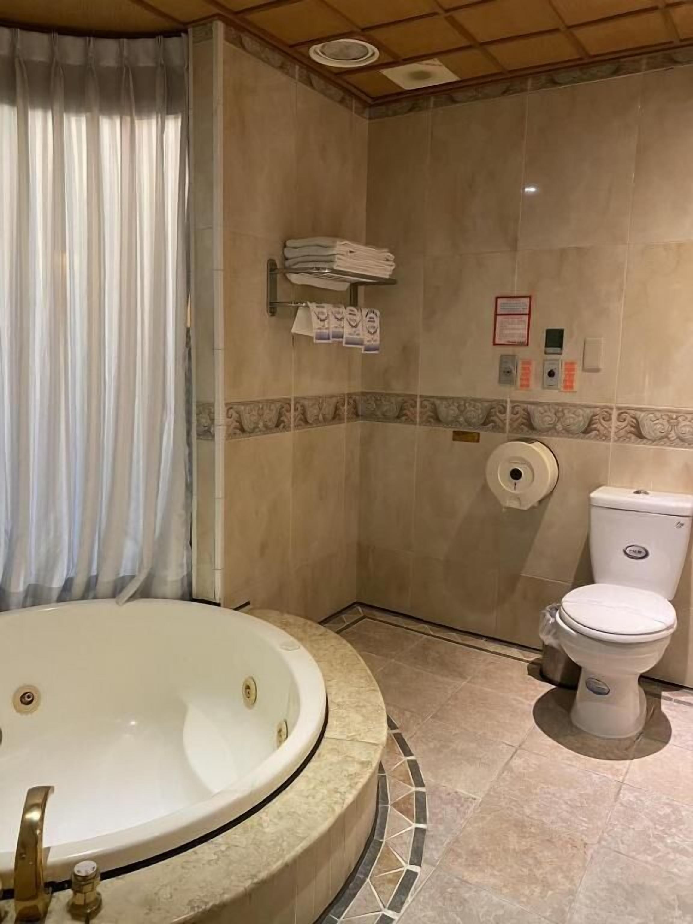 deluxe quadruple room | bathroom | bathtub, free toiletries, hair dryer, slippers