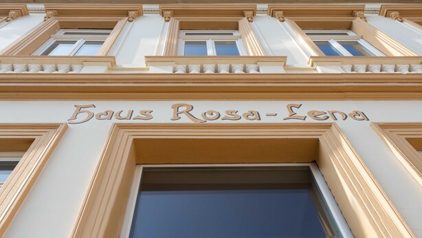 Fachada de un edificio con el nombre "Baus Rosa-Lena" bien visible.