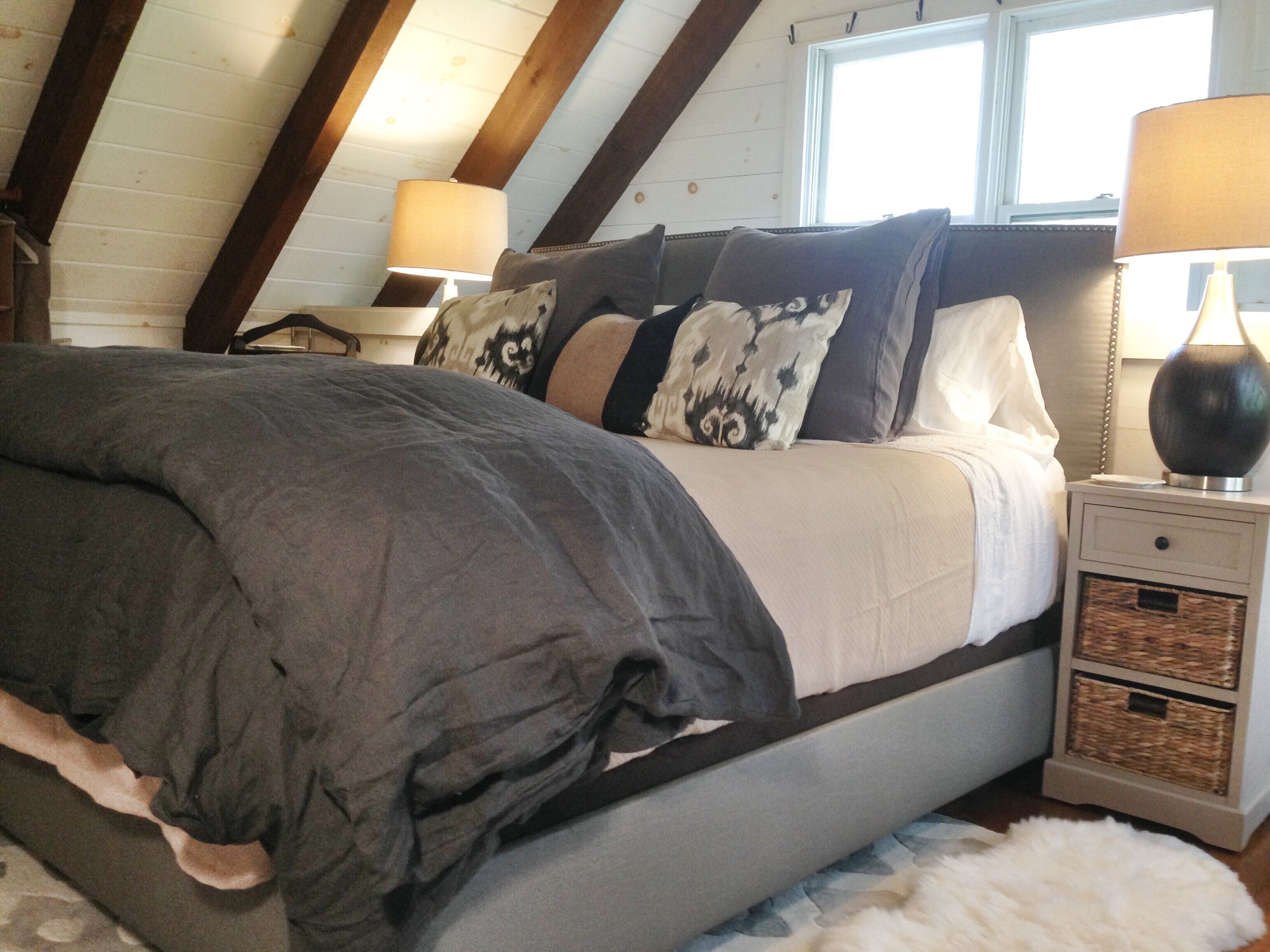 Great light streams into the sleeping loft, under a beautiful beamed ceiling.